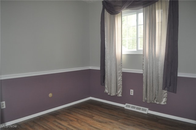 unfurnished room featuring dark wood-type flooring