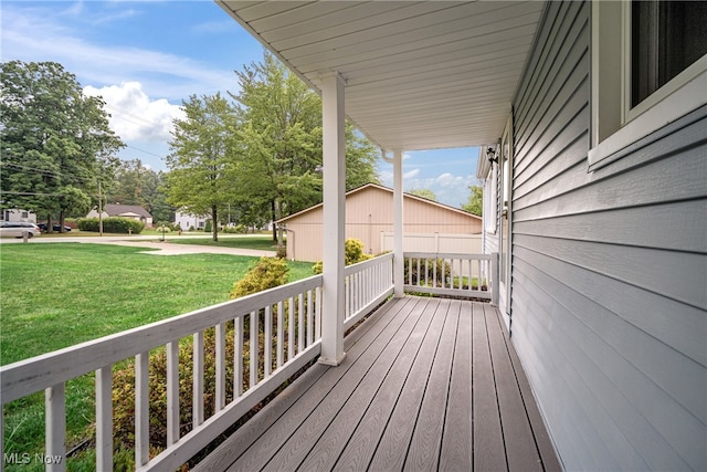 wooden deck featuring a yard