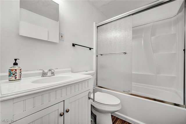 full bathroom with enclosed tub / shower combo, hardwood / wood-style flooring, vanity, and toilet