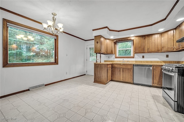 kitchen featuring pendant lighting, an inviting chandelier, appliances with stainless steel finishes, ornamental molding, and light tile patterned floors