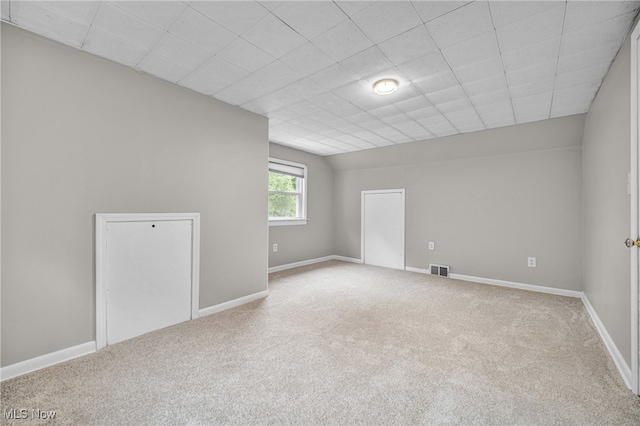 spare room featuring light colored carpet