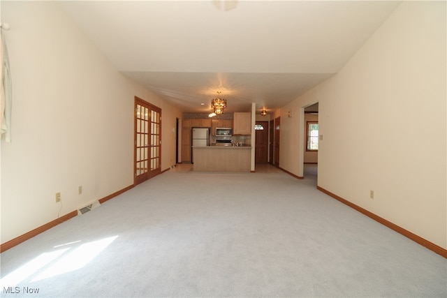 unfurnished living room with light colored carpet