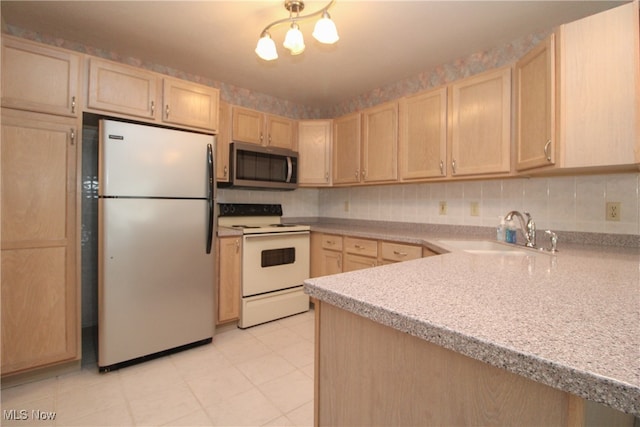 kitchen with light brown cabinets, kitchen peninsula, light tile patterned flooring, stainless steel appliances, and sink