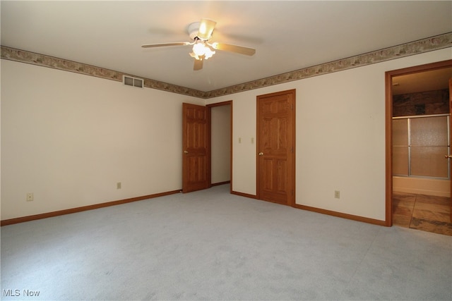 unfurnished bedroom with ensuite bathroom, carpet floors, and ceiling fan