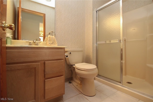 bathroom with an enclosed shower, vanity, tile patterned floors, and toilet