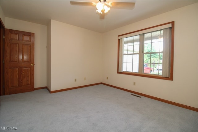 spare room featuring ceiling fan and carpet flooring