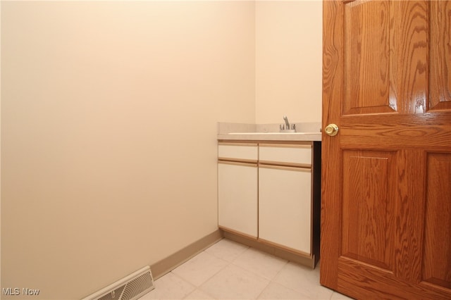 bathroom with sink and tile patterned flooring