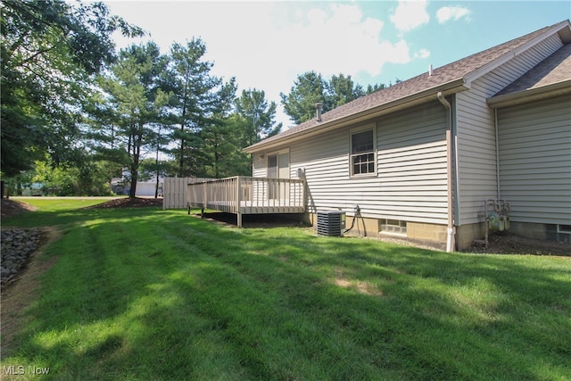 view of yard featuring a deck and central AC unit