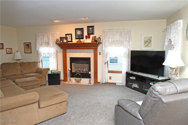 living room with a fireplace and carpet flooring