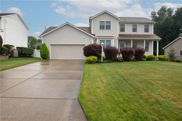 view of property with a front yard and a garage