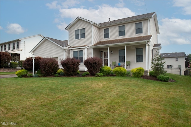 front facade featuring a front lawn and covered porch