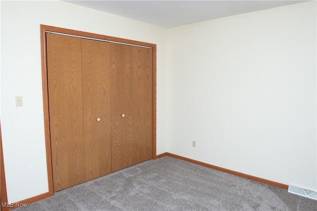 unfurnished bedroom featuring a closet and carpet