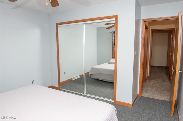 carpeted bedroom featuring ceiling fan and a closet