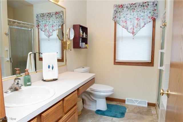 bathroom featuring toilet, tile patterned floors, and vanity