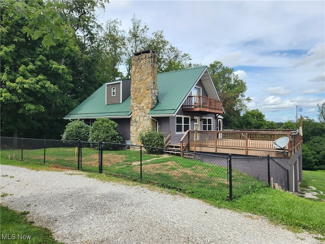 view of front facade with a front lawn and a deck