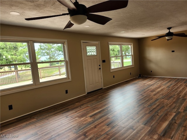 foyer featuring ceiling fan, dark hardwood / wood-style flooring, and a textured ceiling