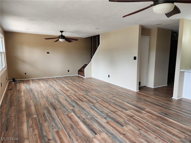 empty room featuring ceiling fan, a textured ceiling, and hardwood / wood-style flooring