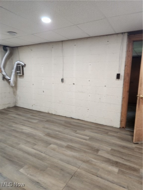 basement featuring a drop ceiling and hardwood / wood-style flooring