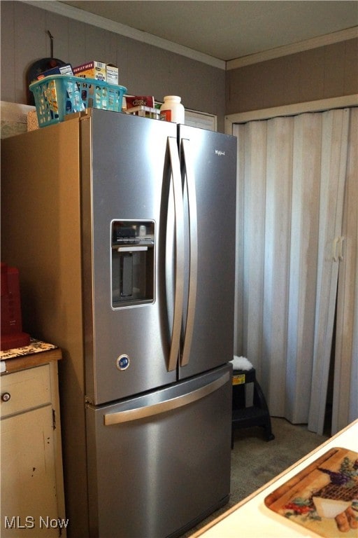 kitchen featuring stainless steel fridge with ice dispenser, carpet flooring, and ornamental molding