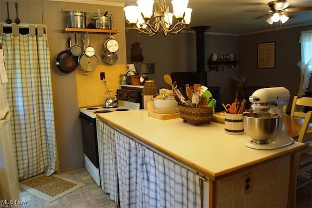 kitchen featuring ornamental molding, ceiling fan with notable chandelier, electric range, and light carpet