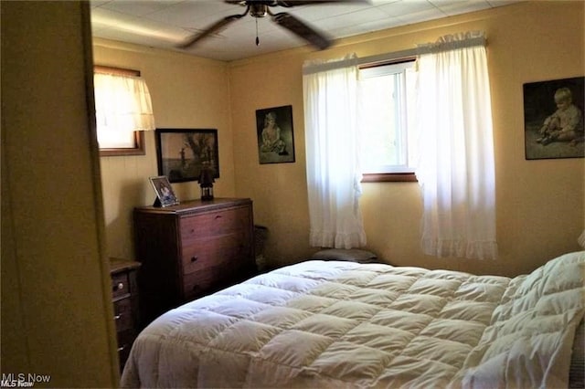 bedroom featuring ceiling fan and multiple windows