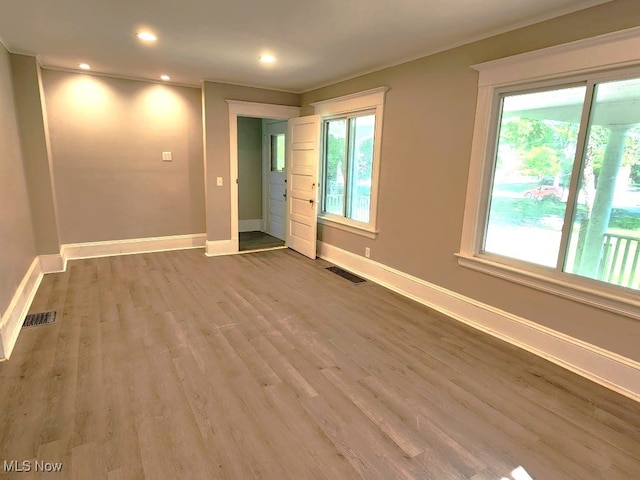 unfurnished room featuring crown molding and wood-type flooring