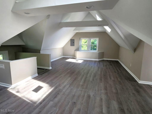 additional living space featuring lofted ceiling, dark wood-type flooring, electric panel, and baseboards