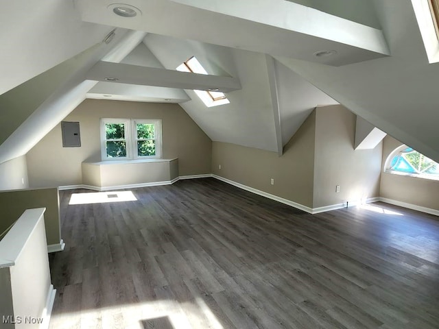 bonus room with wood-type flooring, lofted ceiling with skylight, and electric panel