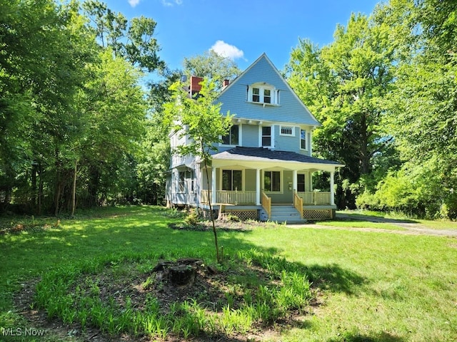 view of front of home featuring a front yard and covered porch