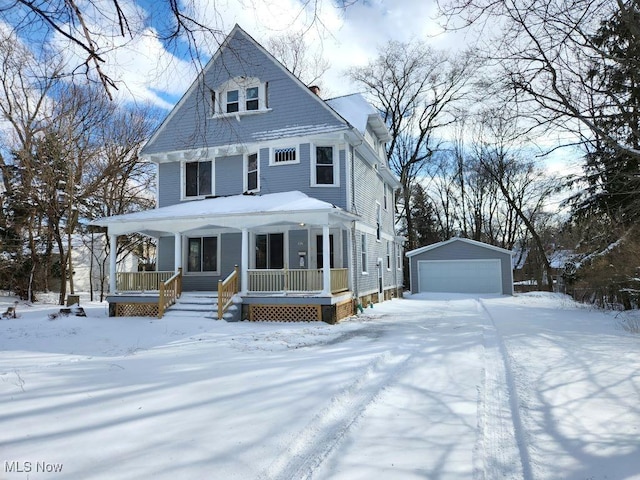 view of front of property featuring covered porch, an outdoor structure, and a detached garage