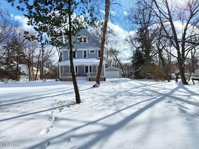 view of front of house with a porch, an outdoor structure, and a garage