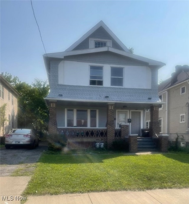 view of front of property with a front yard and a porch