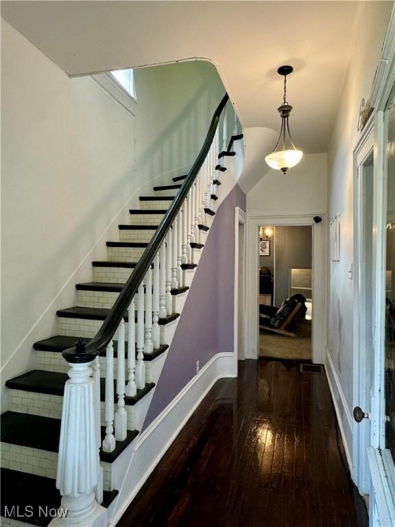 stairs featuring wood-type flooring