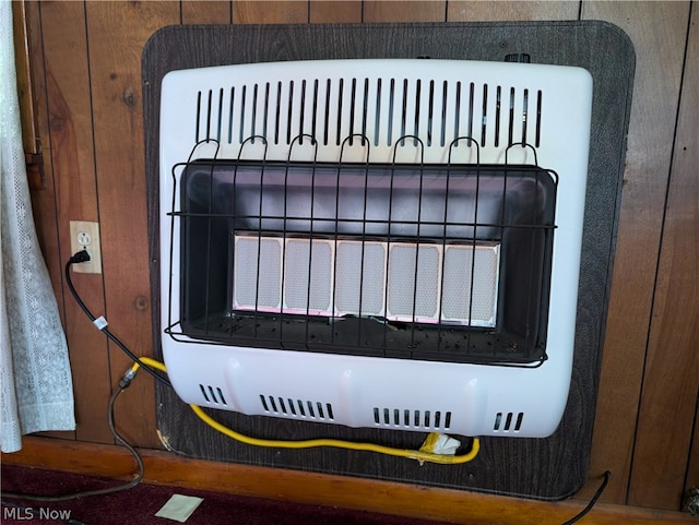 interior details with heating unit and wooden walls