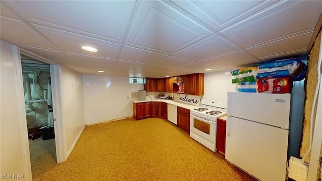 kitchen featuring light carpet, backsplash, and white appliances