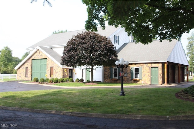 view of front of home with a garage and a front lawn