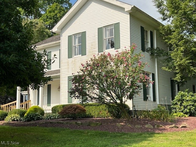 view of side of property with a lawn