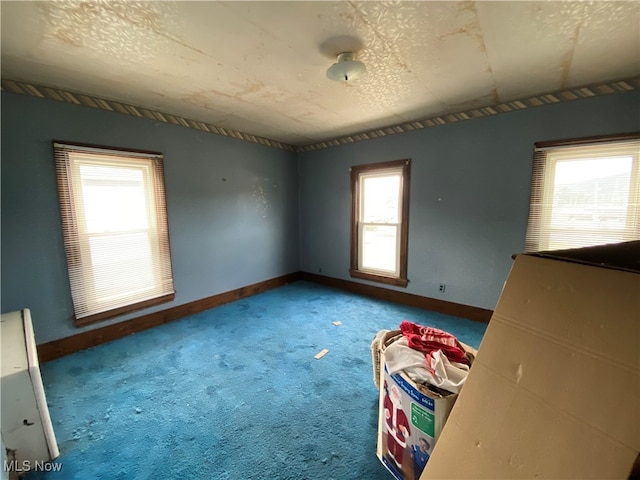 unfurnished bedroom featuring a textured ceiling and carpet