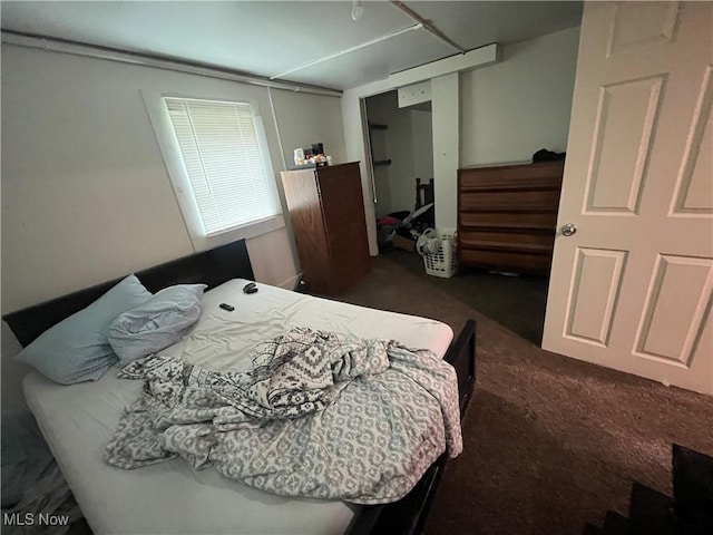 bedroom featuring dark colored carpet