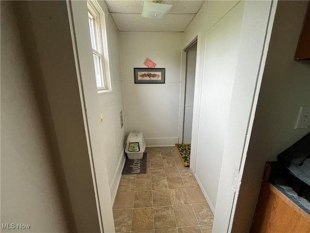 corridor featuring a paneled ceiling