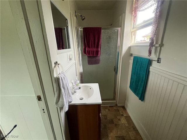 bathroom featuring vanity and an enclosed shower