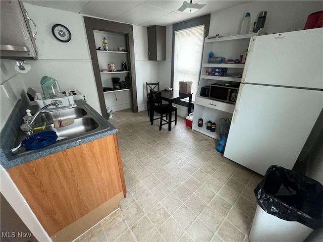 kitchen with white refrigerator and sink