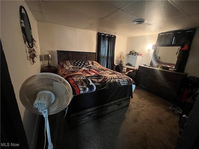 bedroom featuring carpet floors and a paneled ceiling