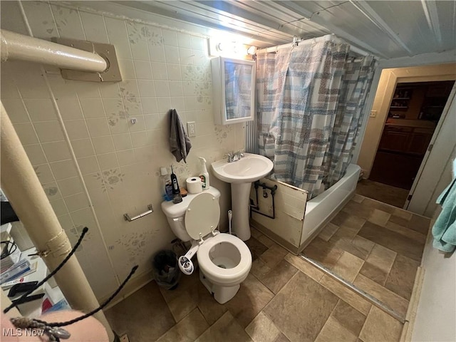 full bathroom with tile walls, sink, toilet, and shower / bath combo