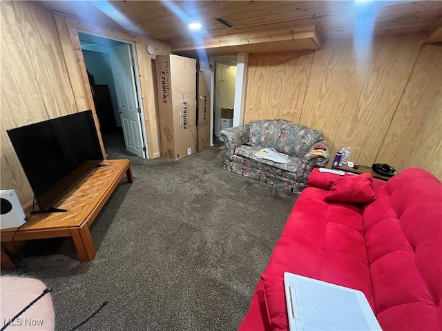 carpeted living room with wooden ceiling and wood walls