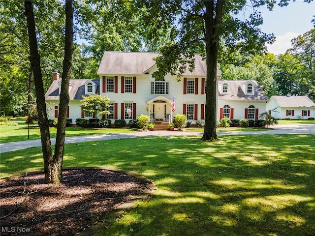 colonial inspired home with a front yard