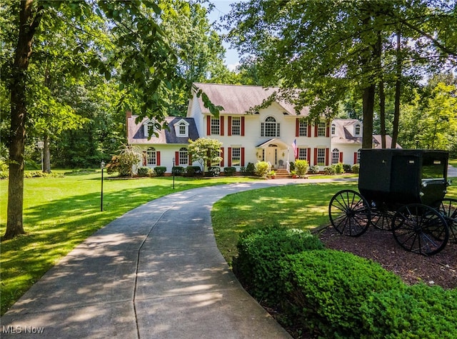 colonial-style house with a front yard