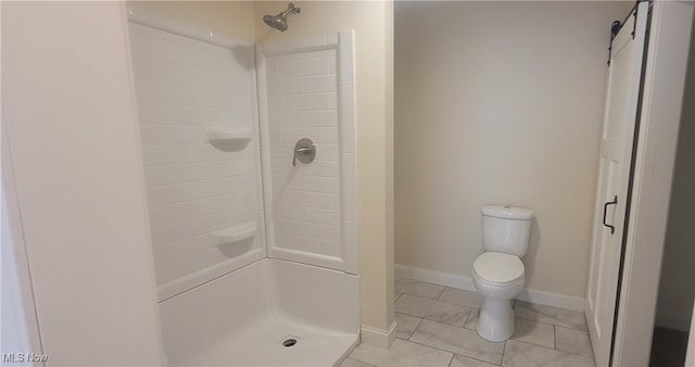 bathroom with tile patterned floors, toilet, and walk in shower