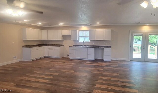 kitchen featuring white cabinetry, french doors, dark wood-type flooring, and sink