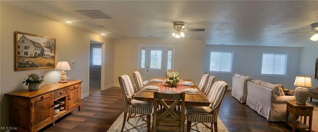 dining area featuring a textured ceiling, ceiling fan, and dark wood-type flooring